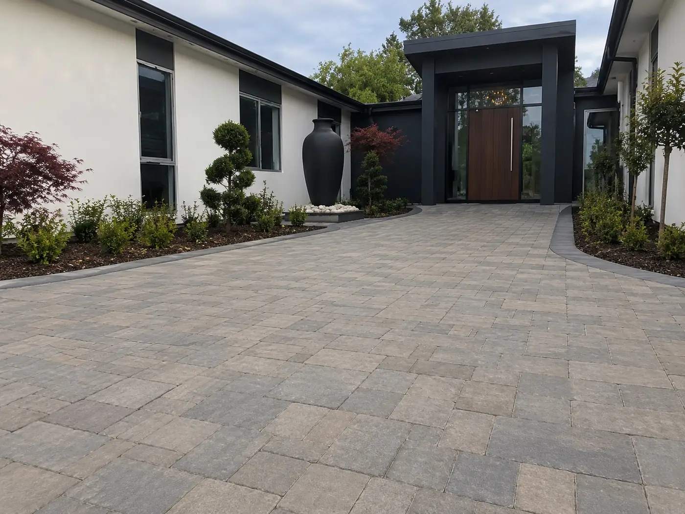 Concrete paver entry court outside a modern home with a timber front door, Cairns