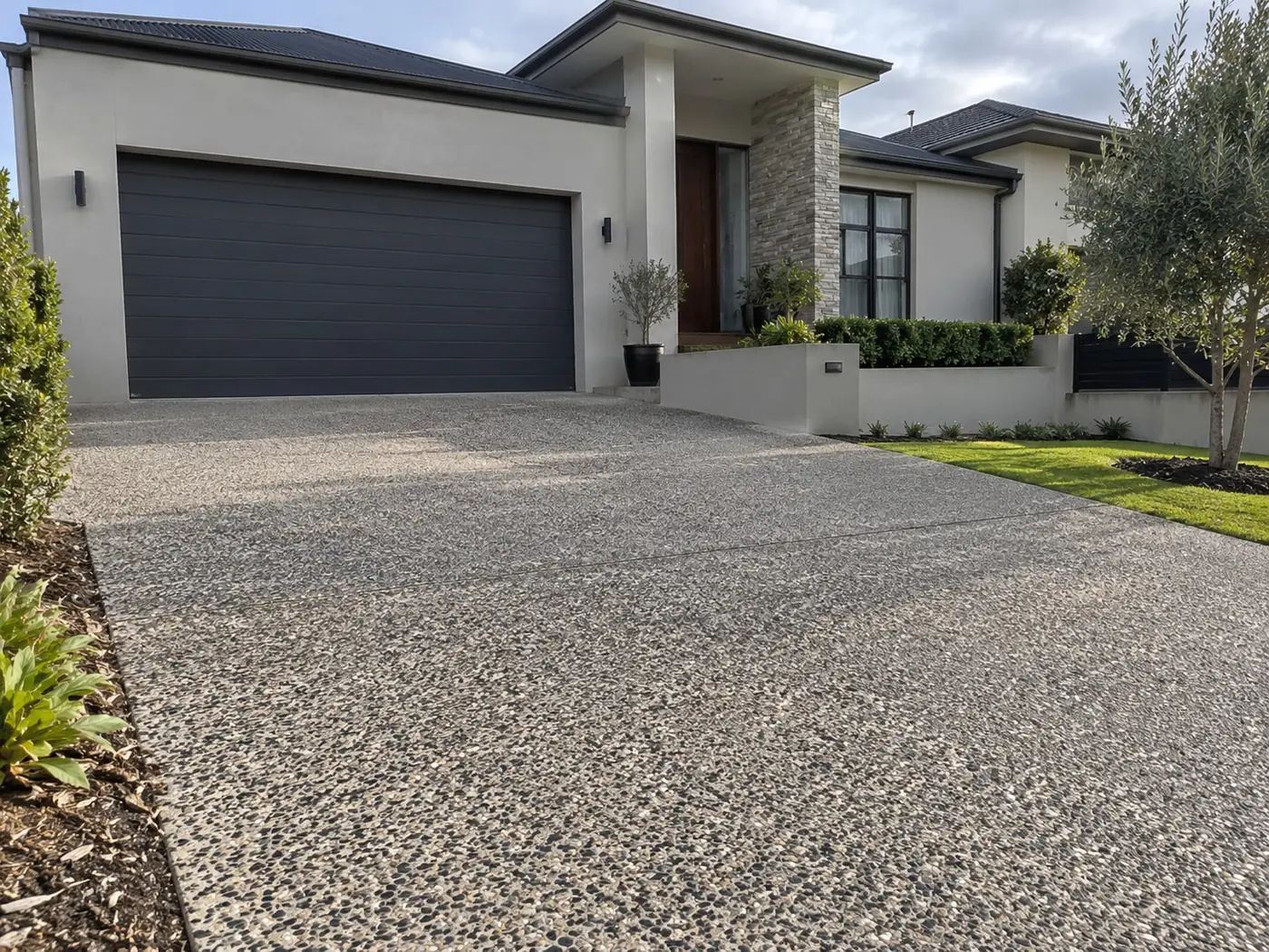 Wide exposed aggregate driveway leading to a double garage, Cairns QLD